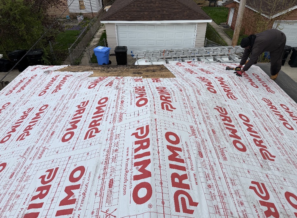 Roofing underlayment being installed before shingle application