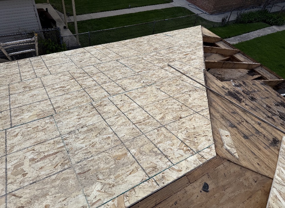 Fresh OSB roof decking installed on a sloped residential roof
